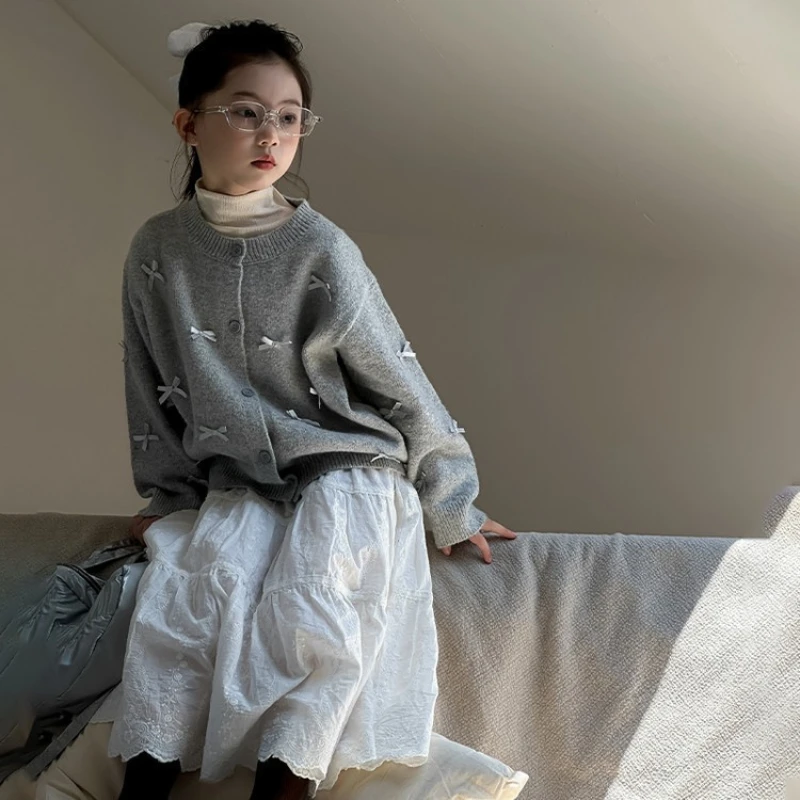 

2025 Autumn New Girls' Bow Warm Knitted Cardigan and Solid Color Cotton Half Skirt Two Piece Set