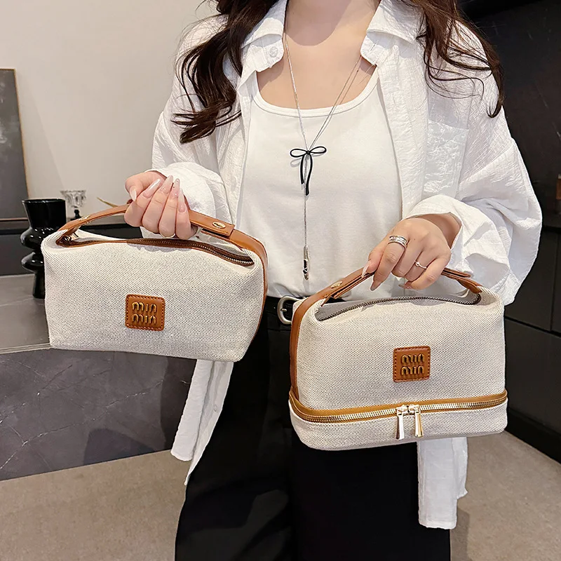 

2025 New Arrival! Metal Logo Retro Luxury Canvas Handheld Makeup Bag - High - End Storage Bag for Cosmetics, Hot Sale!