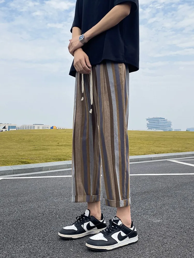 

Летние тонкие мужские повседневные брюки в полоску, свободные прямые брюки-харланы, укороченные, больших размеров, стройнящие, модные, молодежные