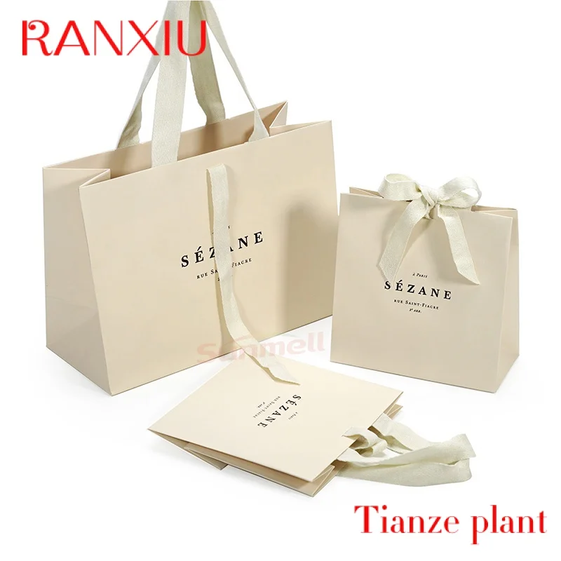 Custom Custom Recycled Ivory Clothes Packaging Gift Bag With Ribbon Handle Luxury Beige Shopping Paper Bags With Your Own Logo