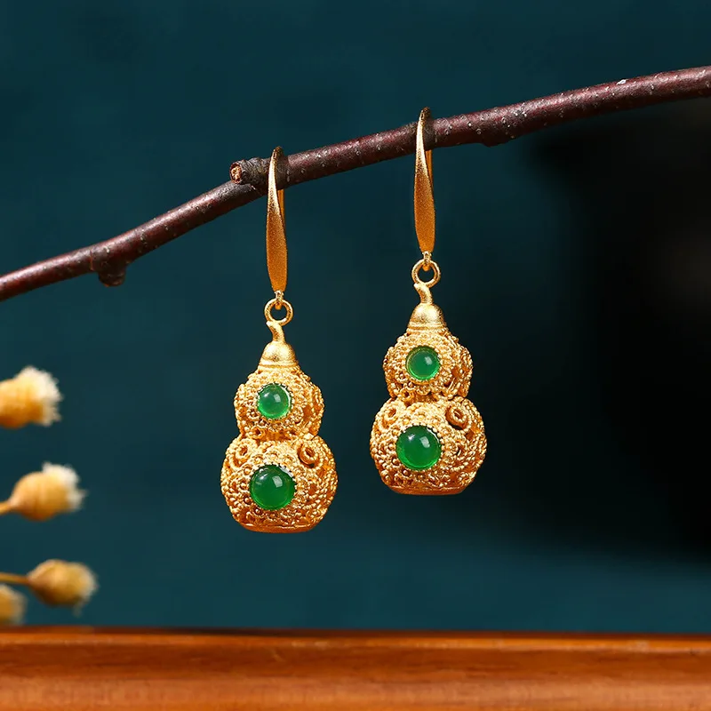 These earrings featuring a classic elegant design with a jade-green gourd motif made of gold-plated material and are r