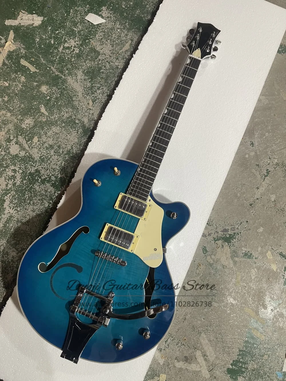 Blue guitar, semi-hollow body guitar, flamed maple top, large tremolo bridge, maple neck, factory custom-made