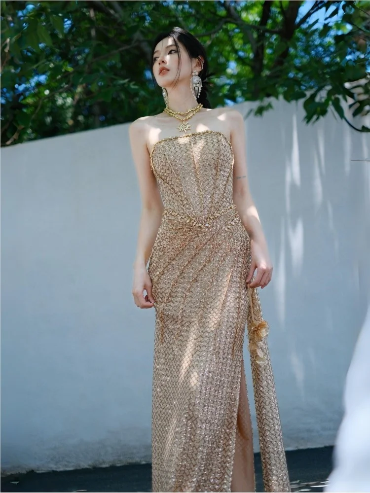 

Heavy sequined strapless and waist-cinching golden dress