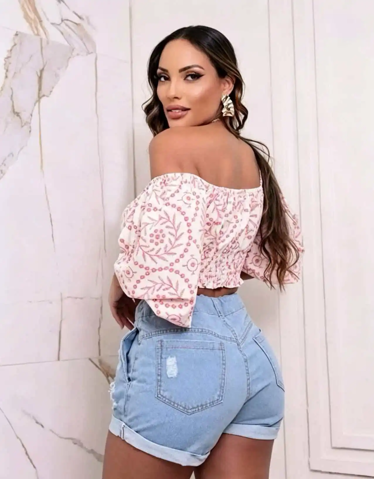 Light blue women's high-waisted ripped denim shorts with an elastic waistband and drawstring, cuffed hems