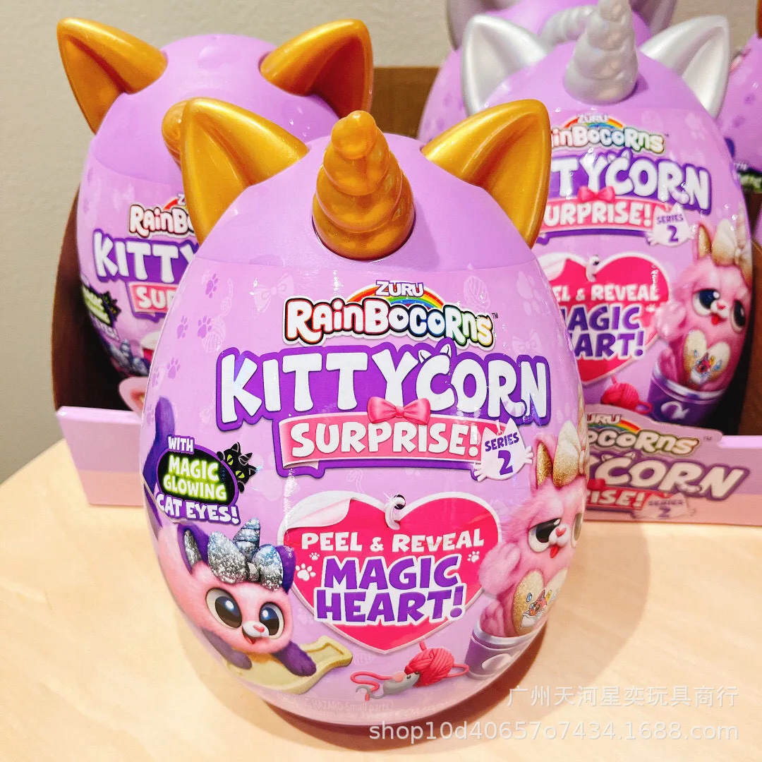 Zuru Auténtico Rainbocorns Kittycorn Sorpresa Serie 2 Ojos de Gato Mágicos Brillantes Peluche de Corazón Mágico con Efecto Peel Reveal Regalos en Forma de Huevo