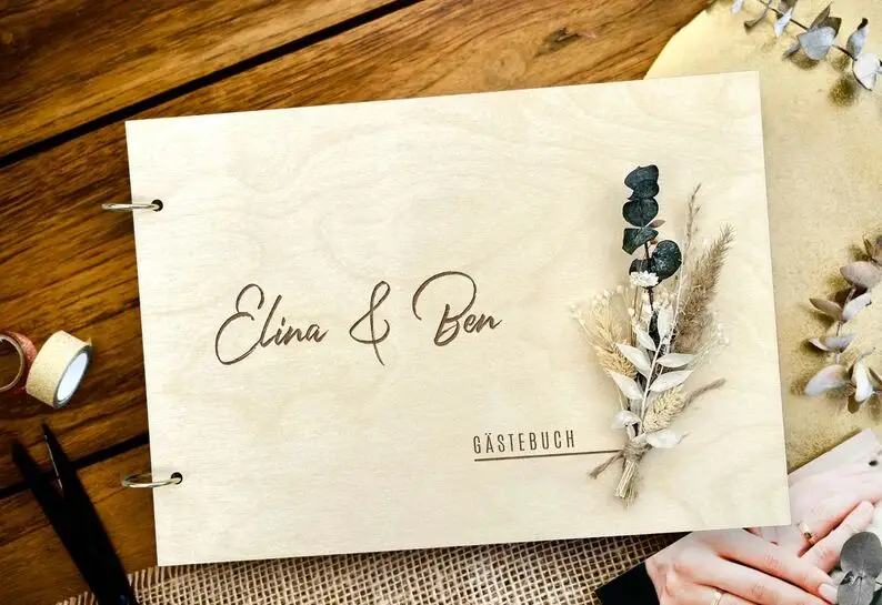 Elegant guest book made of wood for the wedding photo album with dried flowers photo book