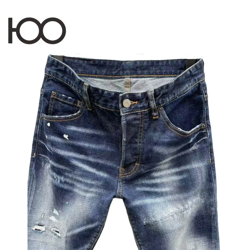 100 C092 Men's denim pants – washed to a rugged vintage finish, with raw-ripped holes and bold paint stamps, cut in a sharp sli