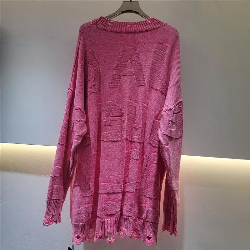 

Chic K-style sweater with lettering & distressed detail. This slouchy, solid-color knit is a trendy must-have.