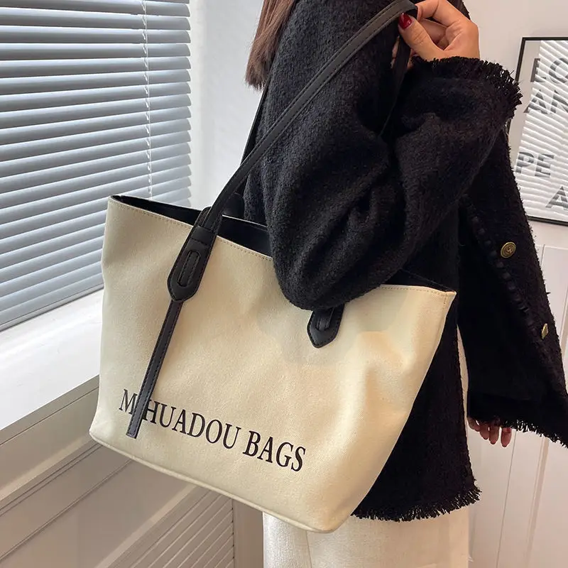 

2024 New Canvas Women's Large Capacity Autumn Fashion Car Sewing Niche Fabric Texture Class Commuting Single Shoulder Tote Bag