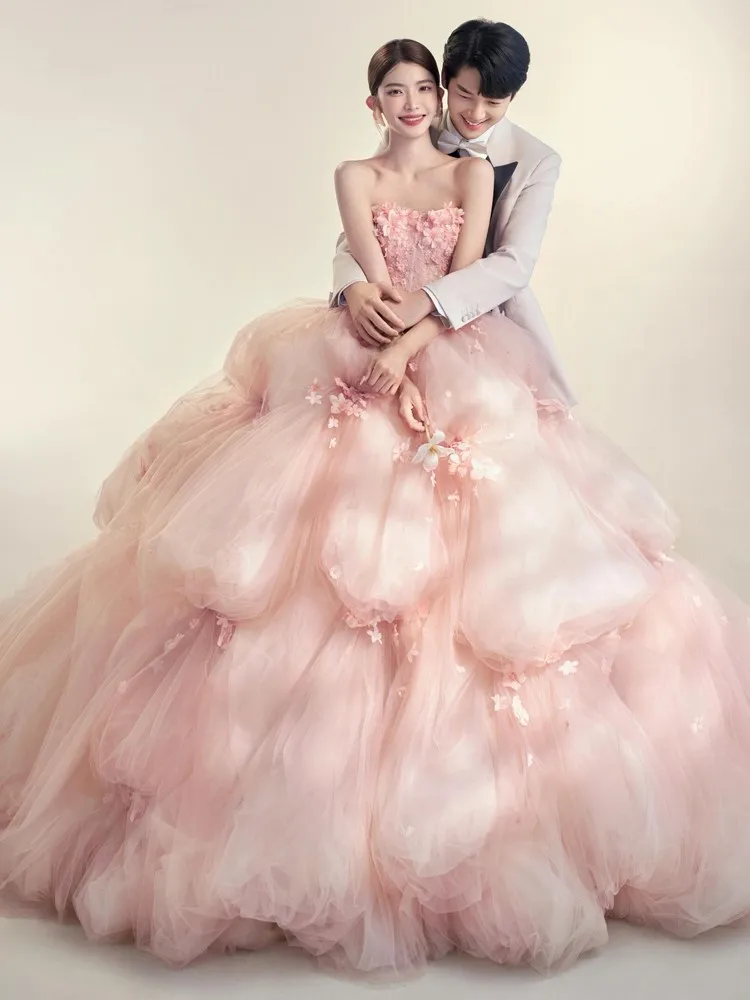 

The theme of photo shoot in studio is pink haute couture with a trailing tail birthday cake and strapless colorful chiffon dress