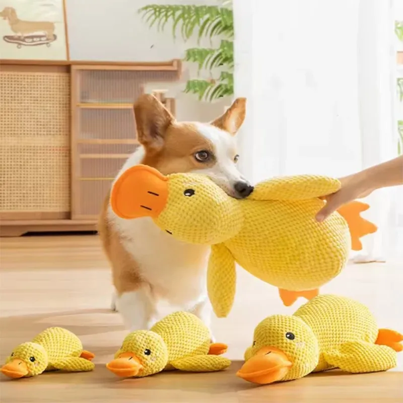 

Dog sleeping with a dog hug duck toys to relieve boredom of little yellow duck pet interactive plush doll pet supplies