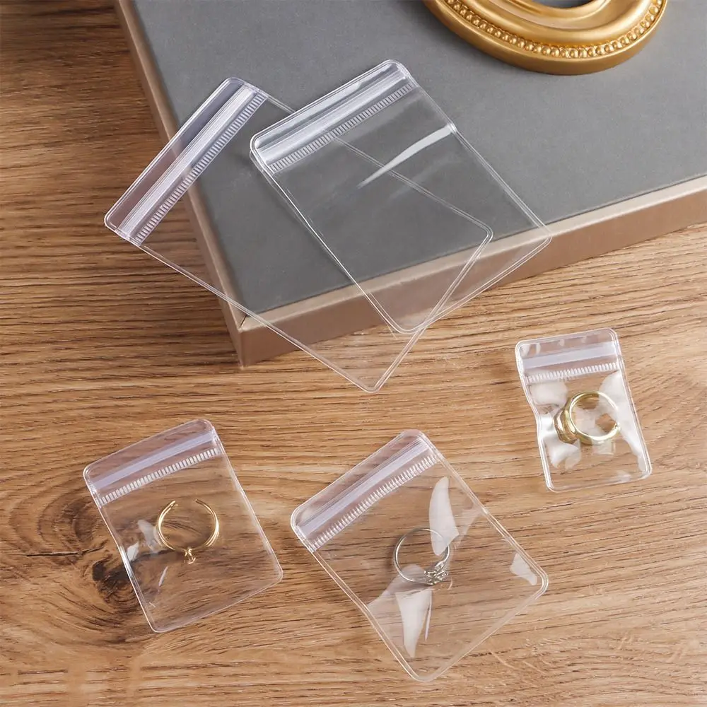 100 Stück neue selbstverschließende PVC-Kunststoffbeutel, staubdicht, wiederverschließbar, mit Reißverschluss, transparente Schmucktasche, Armband, Ring – Detail 4
