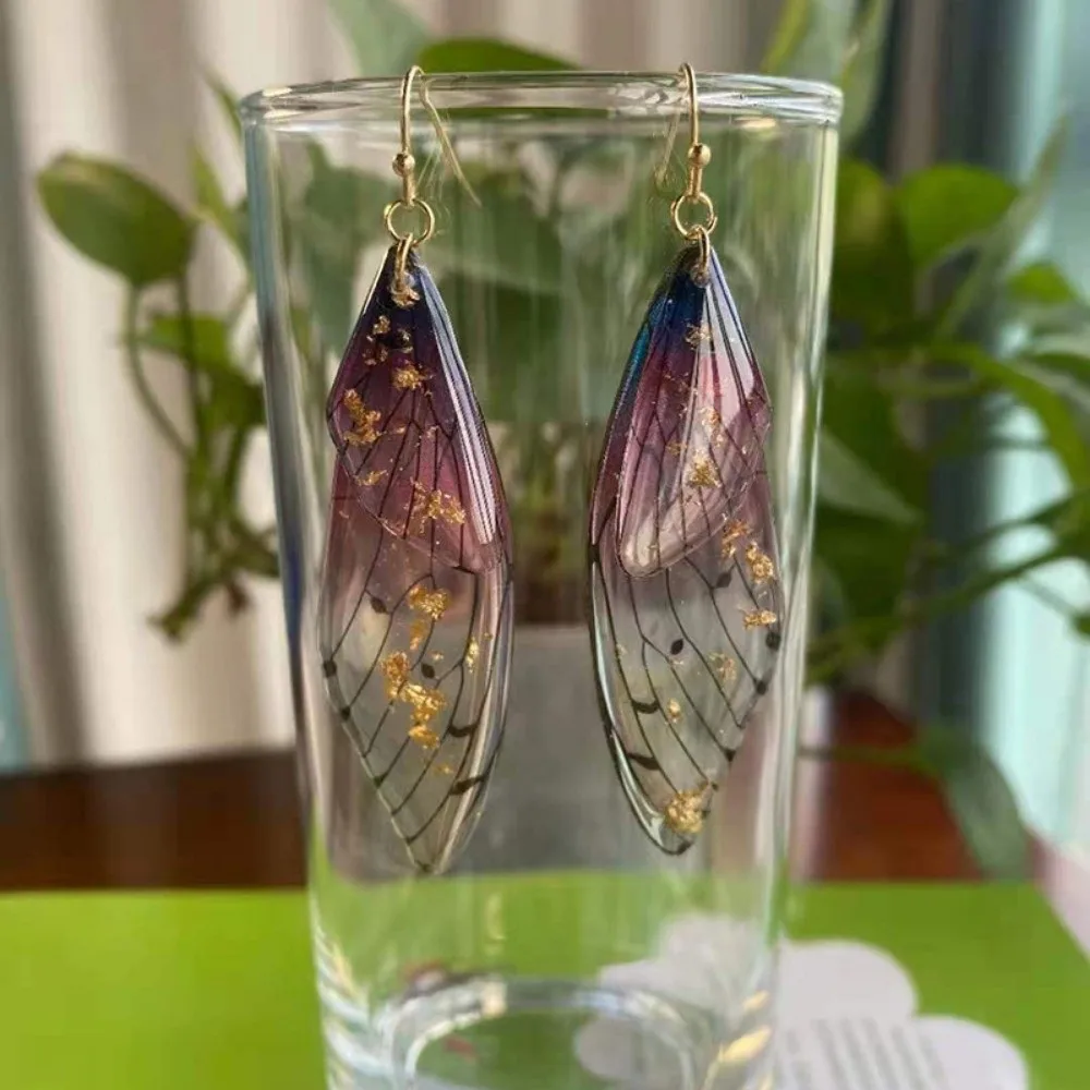 Boucles d'oreilles pendantes Papillon transparentes avec strass dégradés, effet feuille brillante et ailes simulées en résine