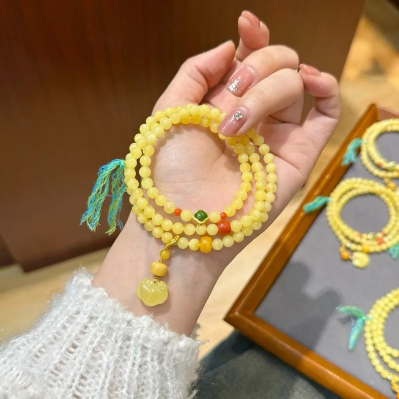 Natural Russian bracelet with three strands featuring a small lock charm 5mm amber beads