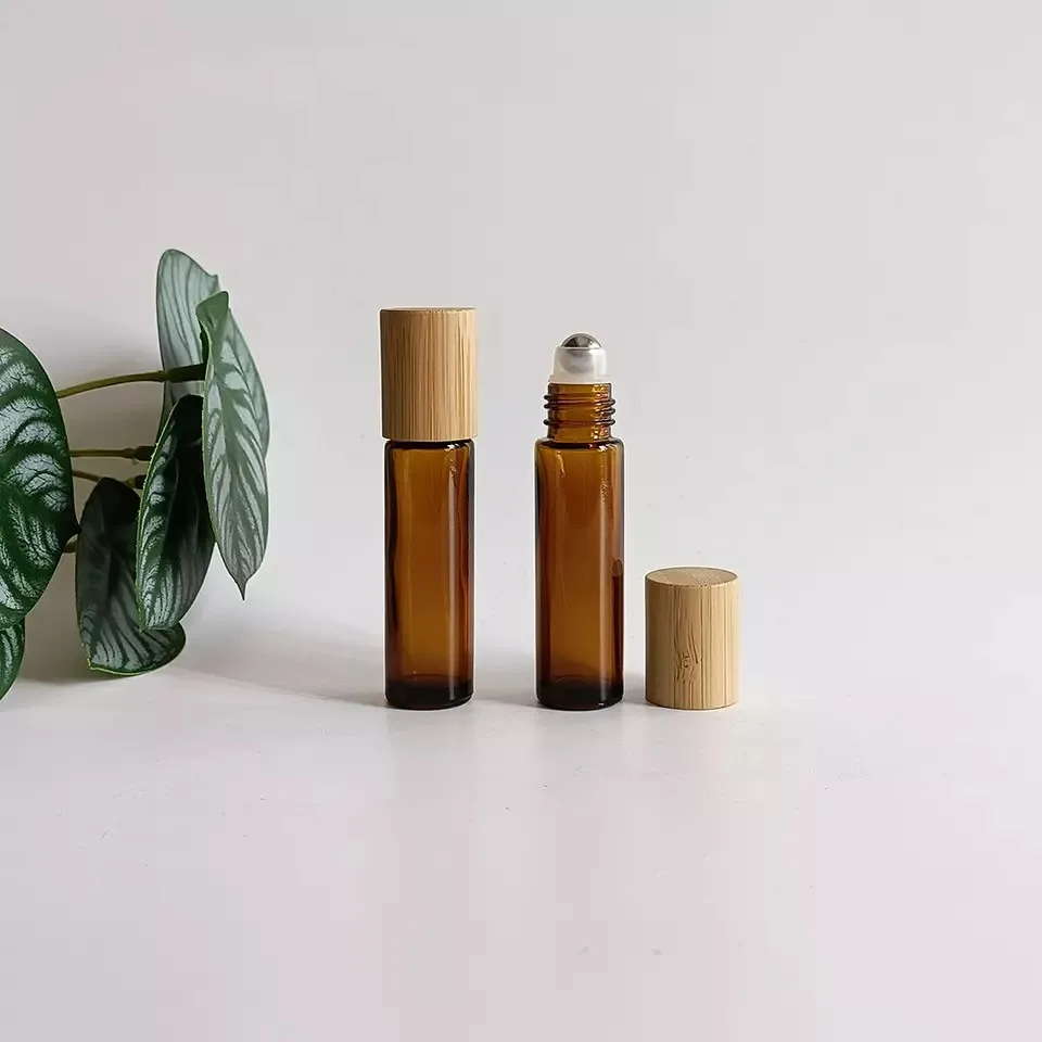 

Wholesale Empty 10ml Round Amber Glass Eaaential Oil Roll On Bottle With Steel Roller Ball Bamboo Lid Refill Cosmetic Container