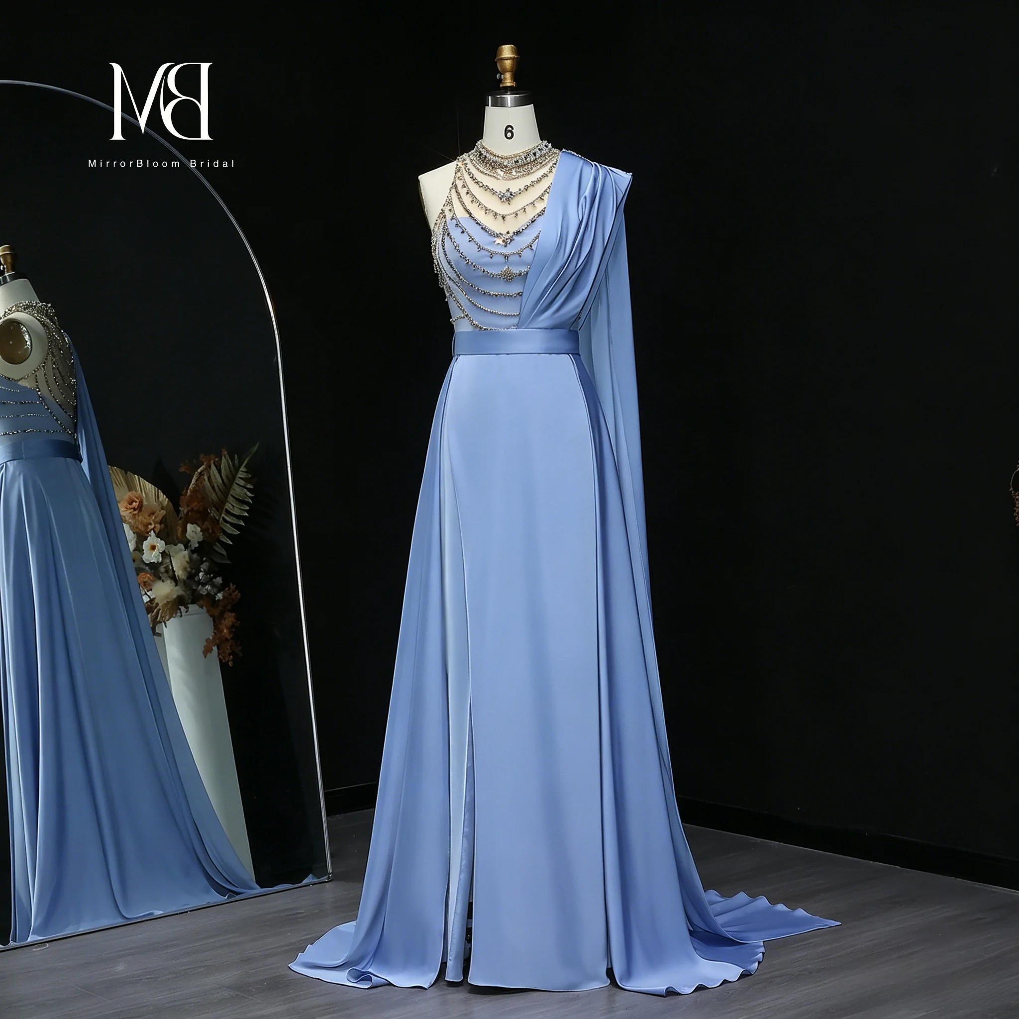 Blue strapless sleeveless one-shoulder formal ball gown featuring an A-line floor-length skirt a beaded necklace and an openback