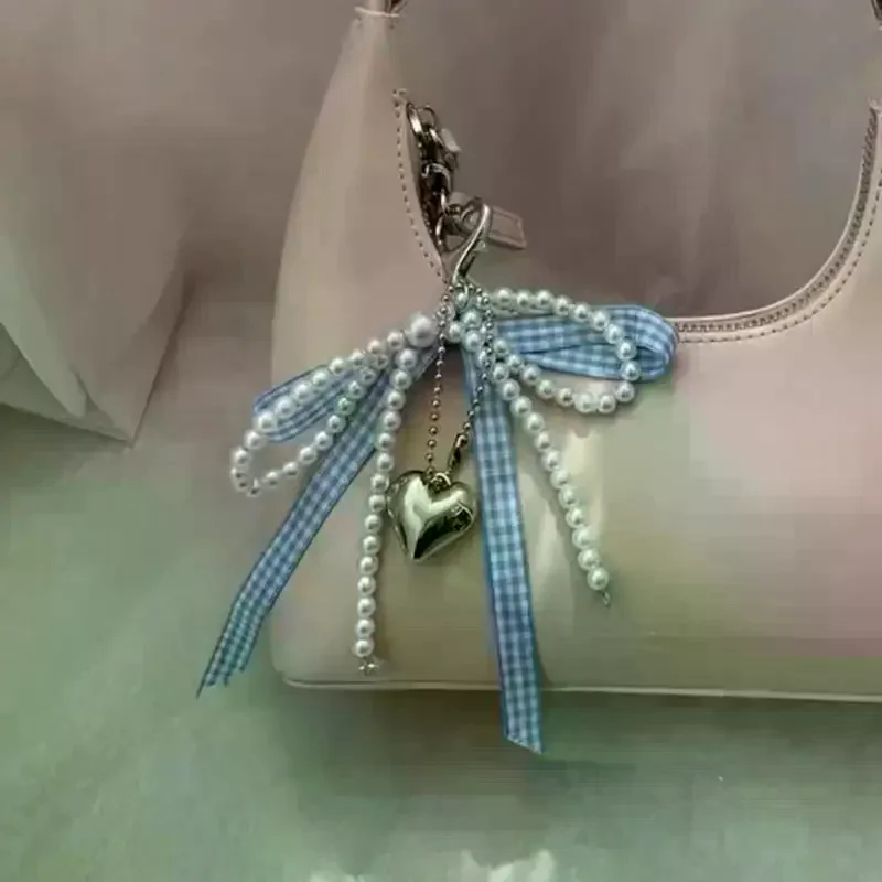 Fotografia 4: Chaveiro feminino elegante com laço em forma de pérola para celular, pingente de bolsa e acessório.