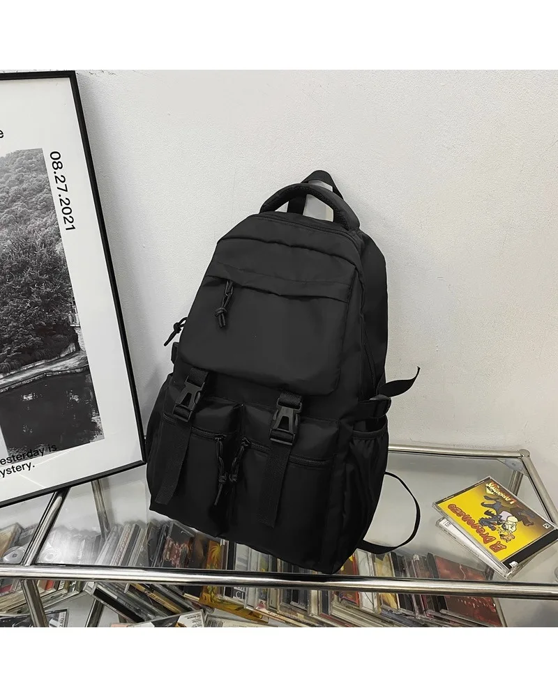Black functional backpack with plush toy charm multi pocket design water resistant fabric for students daily school use