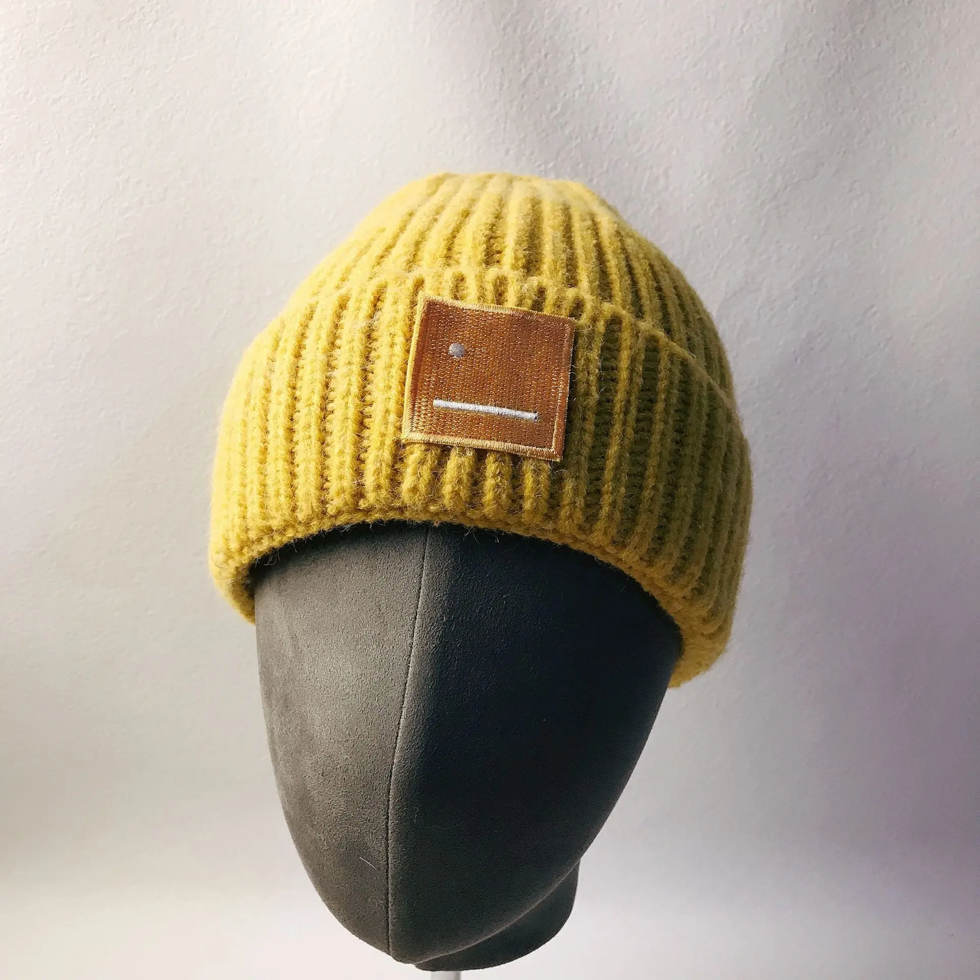 

Autumn and winter European and American warm and cold-proof wool smiley knitted hat woolen hat thickened flanging pullover cap