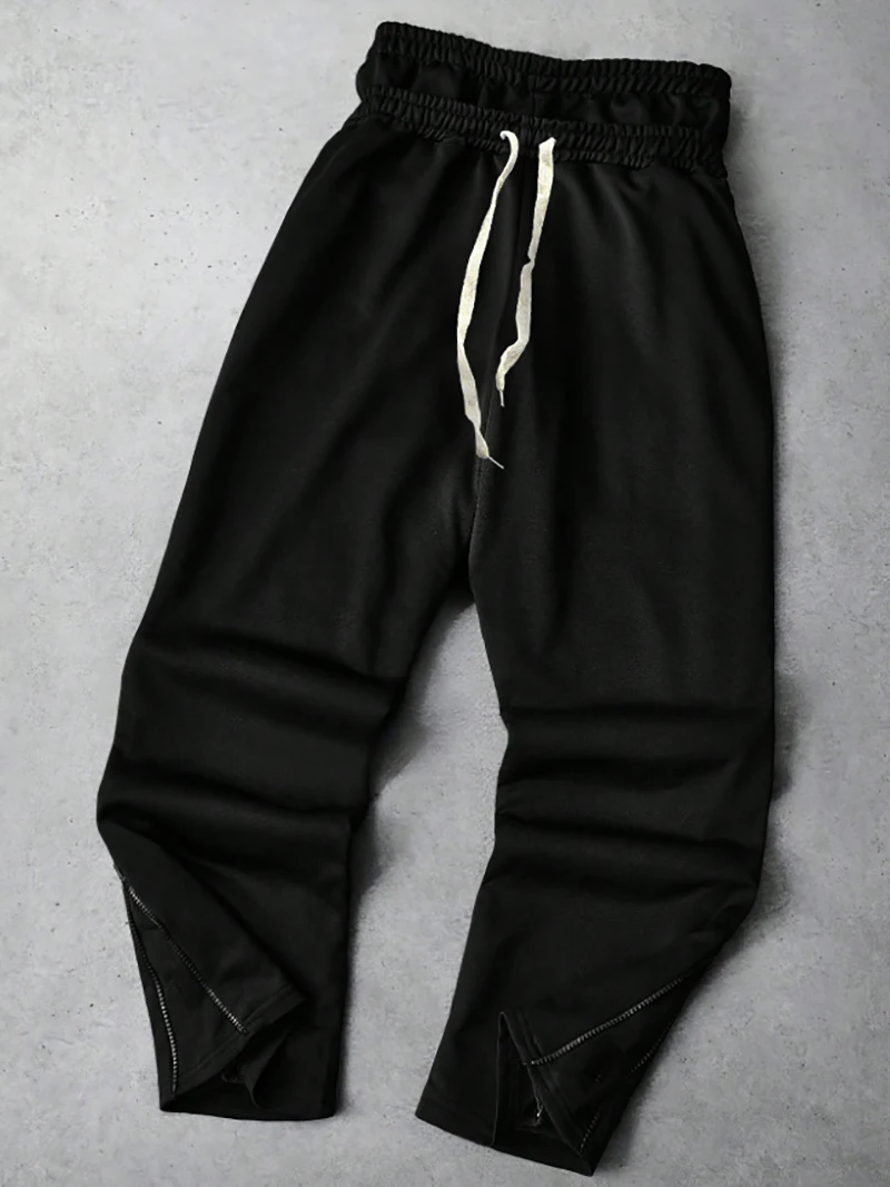 Pantaloni sportivi da uomo in tinta unita con design in due pezzi finto nero stile sportivo da strada alla moda autunno e inverno