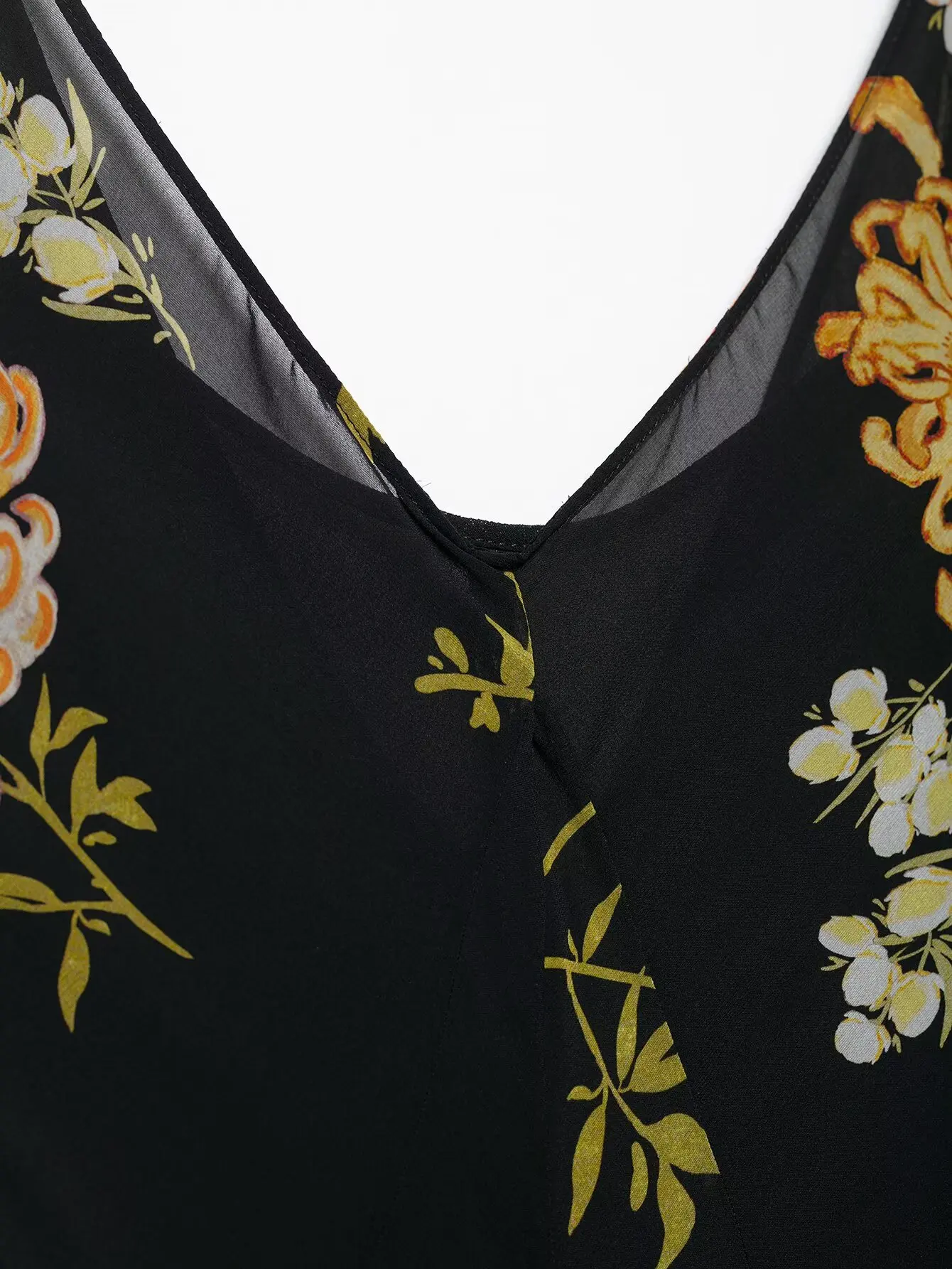   Damska sukienka midi bez rękawów z dekoltem w kształcie litery V, zdobiona kwiatami, rozkloszowana, idealna na lato, zapewniająca szykowny i zwiewny wygląd.