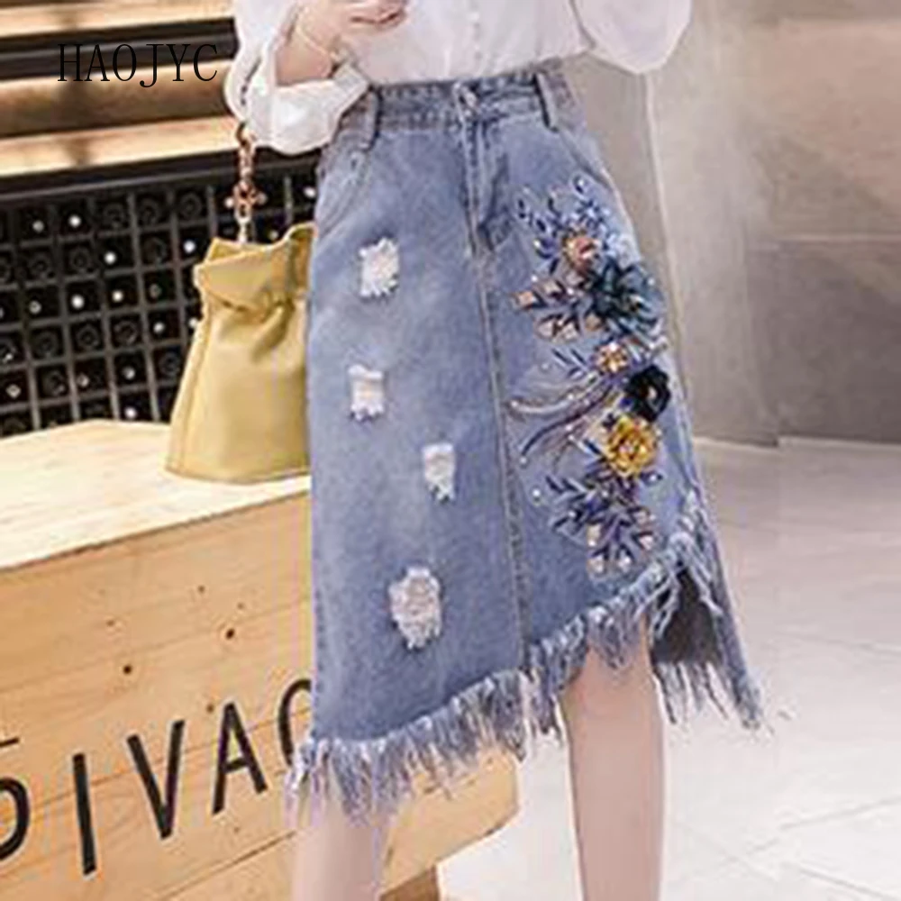 

2025 summer new fashion denim skirt women's mid-skirt high waist A-shaped embroidery tassel hole tide