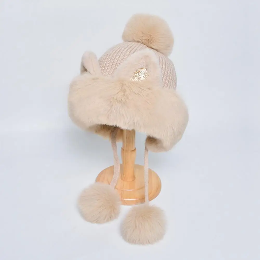 This hat is in the shape of a cat. It has fluffy ears and pompom, which is very cute.