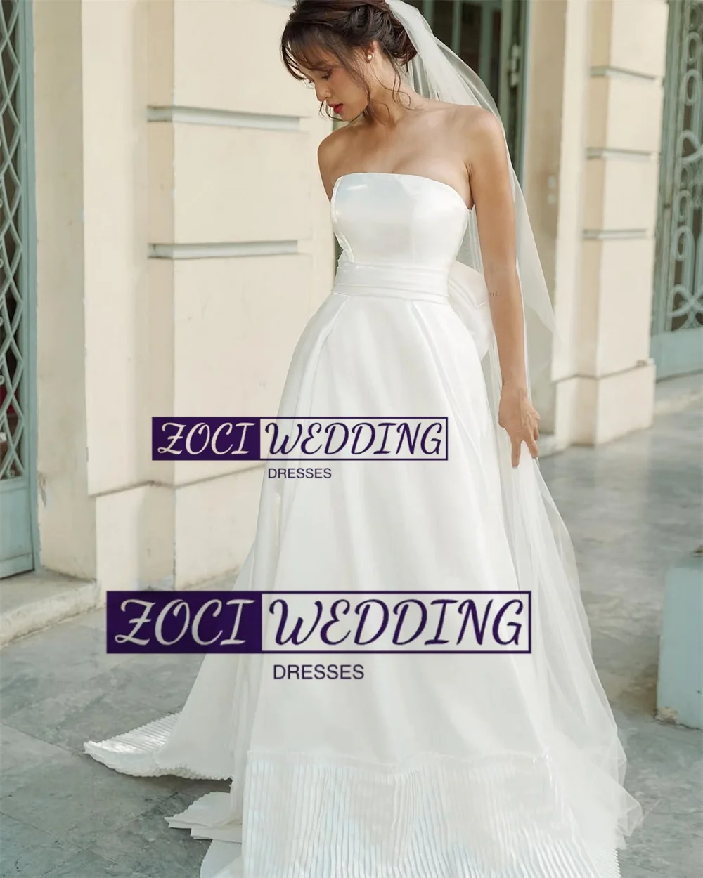 Zoci Moderne trägerlose Korea-Hochzeitskleider, Satin-Falten, mehrlagiges Fotoshooting-Kleid, maßgeschneidertes, rückenfreies Brautpartykleid mit großer Schleife