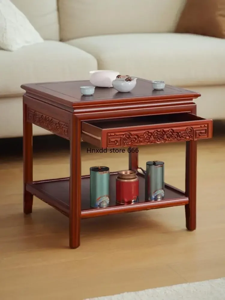 corners on the side of the sofa,  small coffee table, Chinese tea table cabinet fish tank rack, and a bonsai stone.