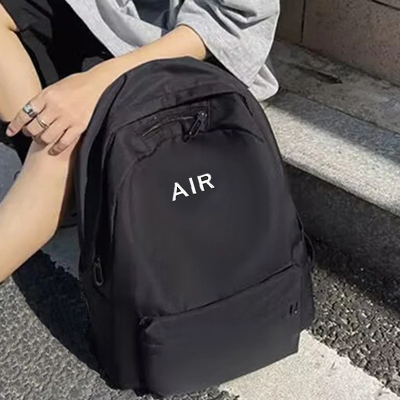 حقيبة ظهر ذات طراز محايد للرجال والنساء، مناسبة للسفر والاستخدام المدرسي. مع تصميم مطبوع عليه حروف.