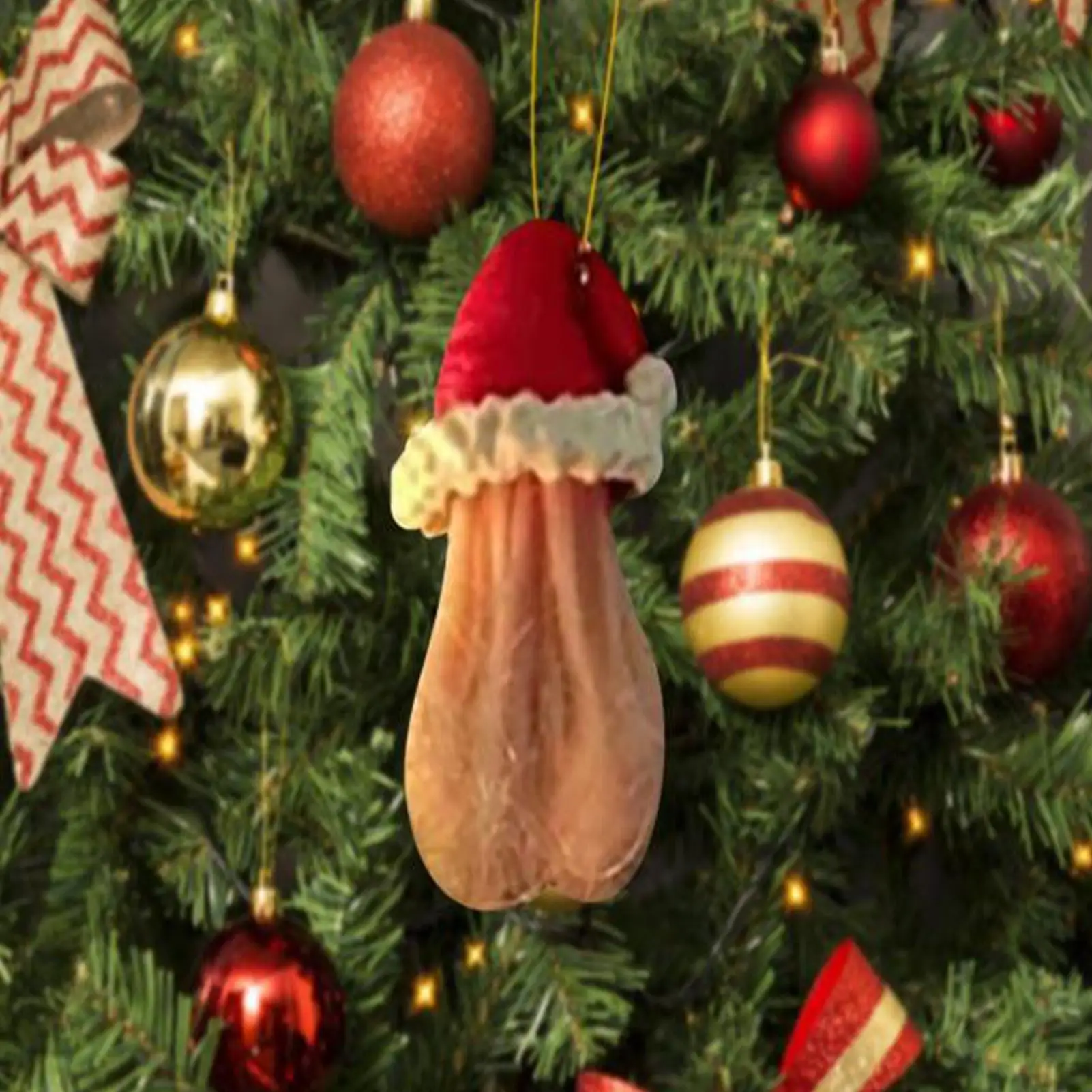 Santa hat egg ornament in coffee-brown resin hanging on a Christmas tree