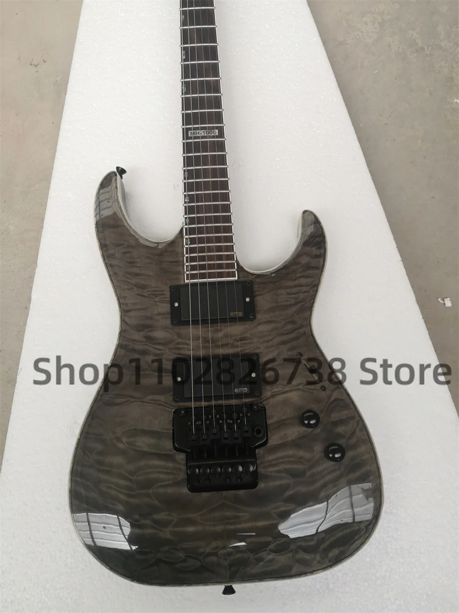 

Clear black electric guitar Squilted Maple Top Maple neck Set In body Rosewood fingerboard 1000 inlaid tremolo bridge closed pic