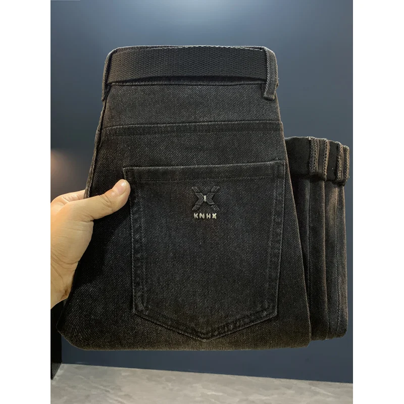 جينز أسود للرجال 2025 خريف جديد ملابس للرجال الراقية العلامة التجارية العصرية القدم الصغيرة عادية مطاطا بنطال ملاصق للجسم