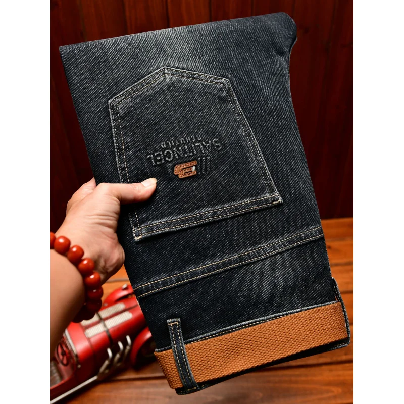 الخريف الراقية الجينز الرجال تصميم الأزياء نسخة ضئيلة صالح مع أقدام صغيرة 2025 الاتجاه الجديد النسخة الكورية السراويل المرنة