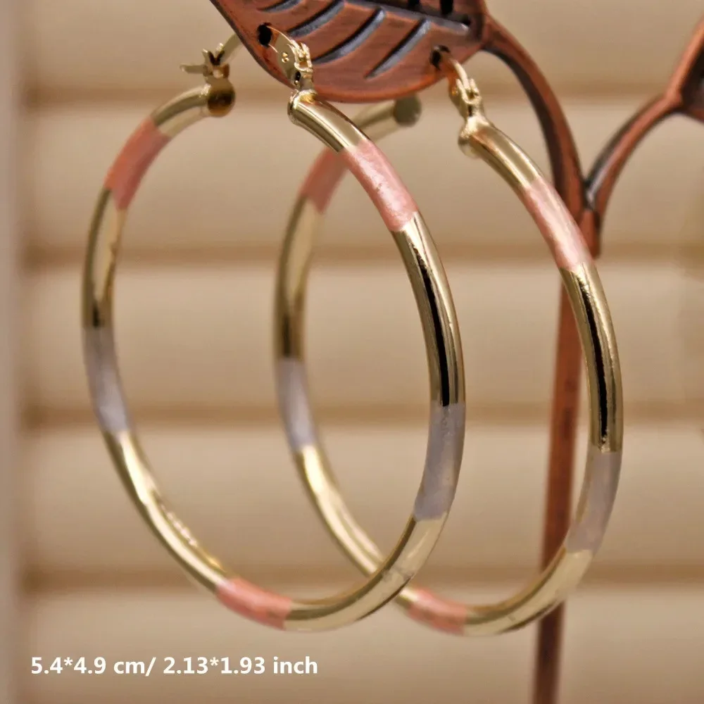 Fashionable women's earrings made of vintage copper, with a golden large hoop and twisted ear wire
