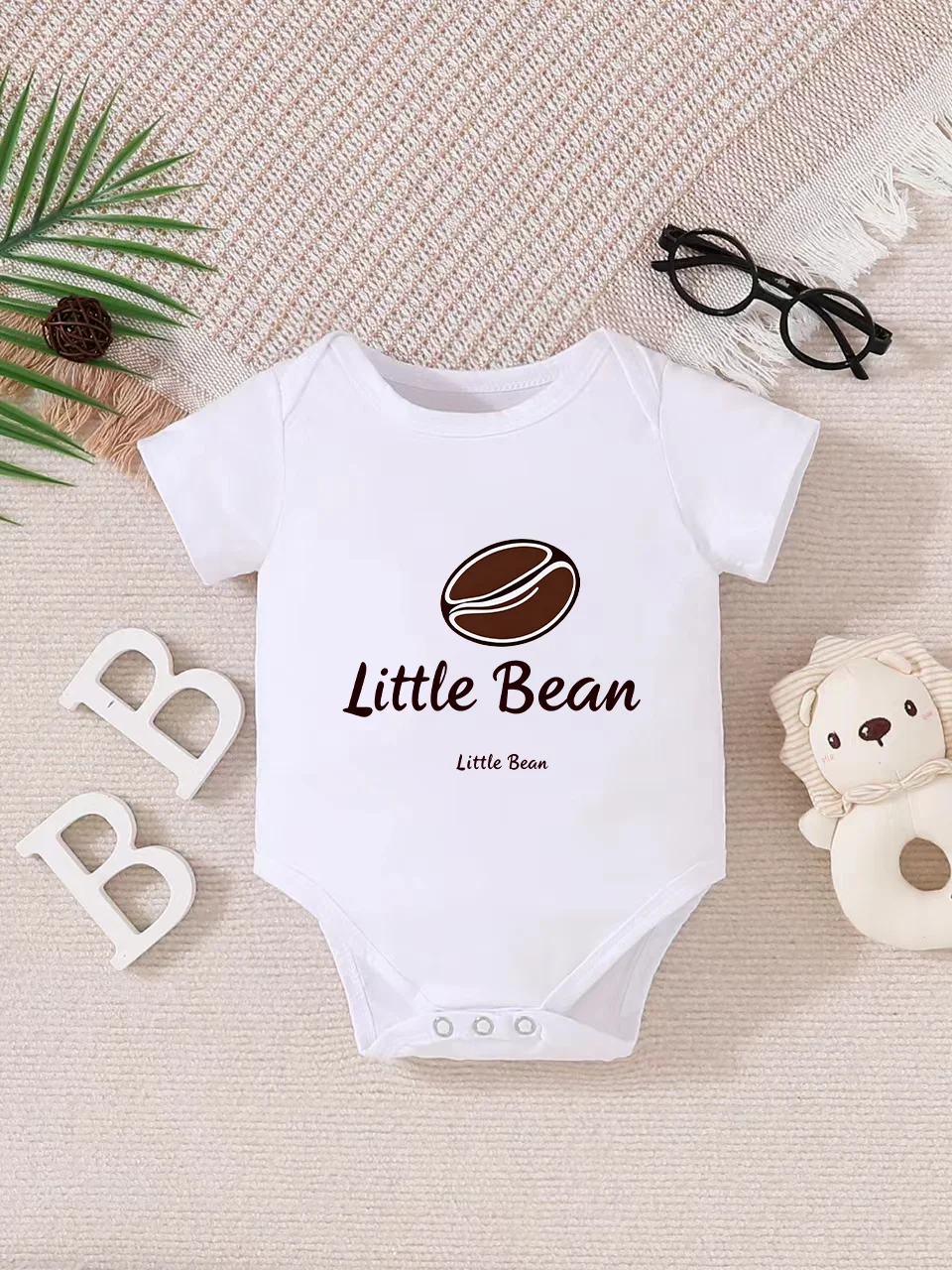 Playful letter-printed baby short-sleeve triangle bodysuit. Button closure for easy dressing, machine washable
