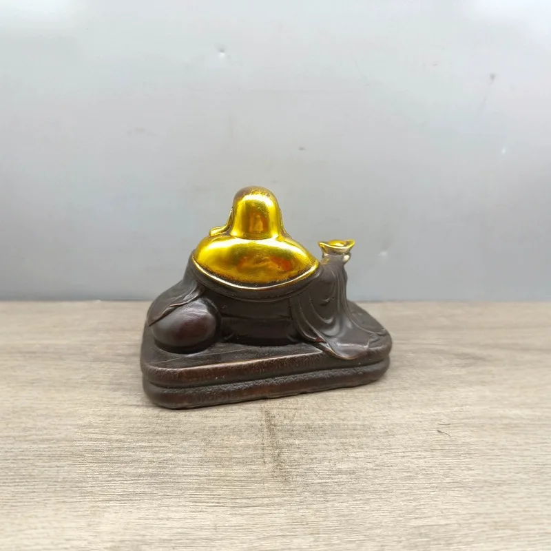 Various copper ornaments, Laughing Buddha figurines, antique collectibles, home decor items, and decorative crafts