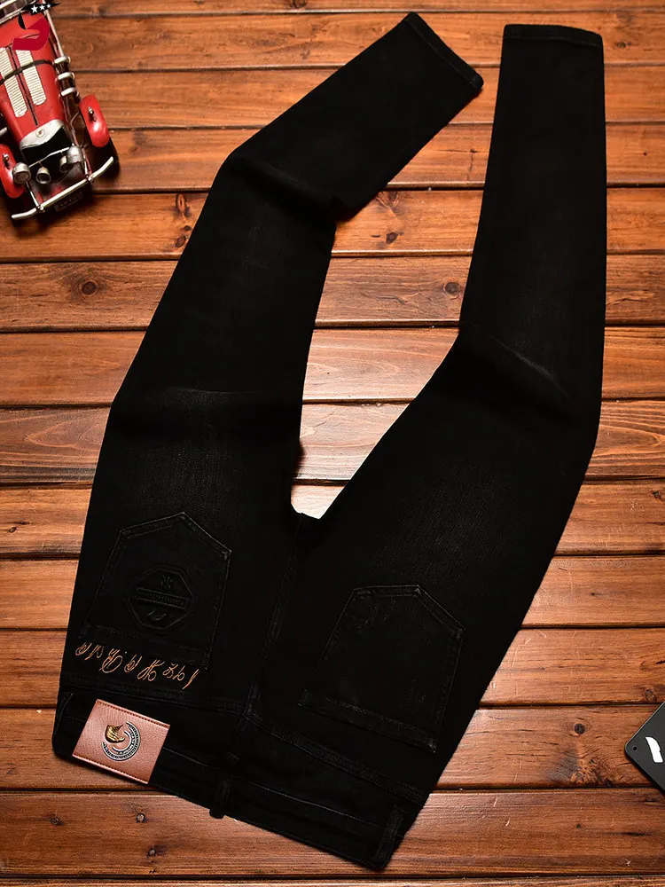 

High end black jeans men's slim fit small feet trendy brand embroidered embossed Korean version fashionable elastic pants