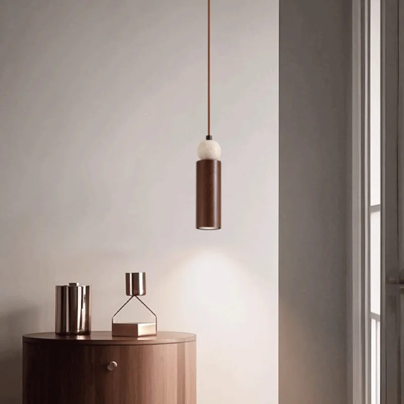 The bedroom bedside is decorated with serene and elegant yellow cave stone entrance LED environment walnut colored pendant light