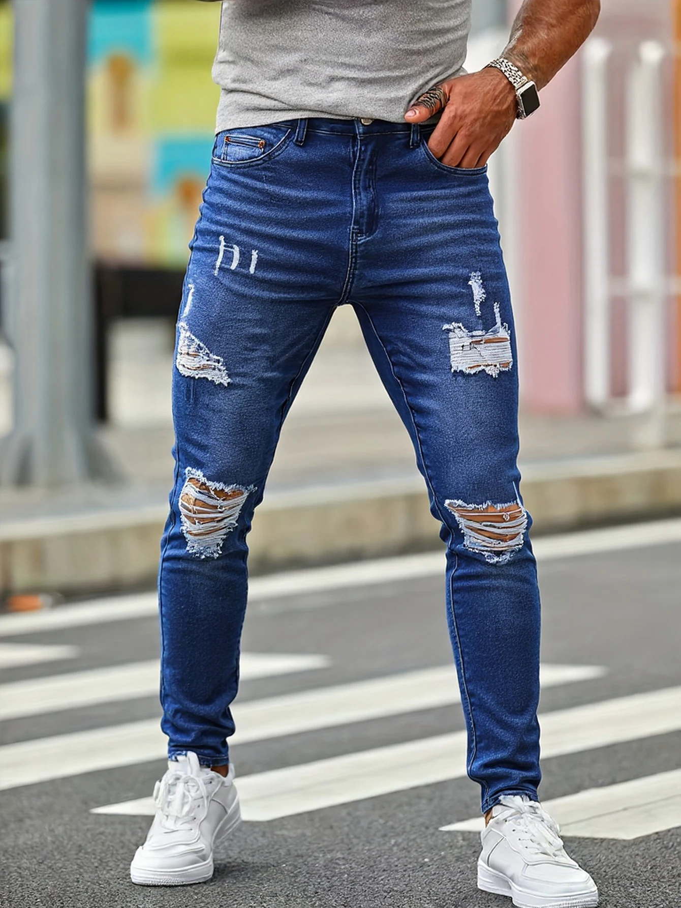 

Men's blue distressed skinny jeans, featuring a unique worn-out design that fits the body shape perfectly, making it easy to cre