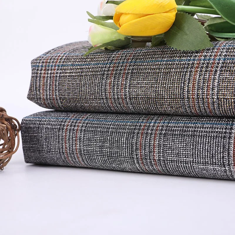 

New women's suit fabric with a shiny checkered pattern made of gold and silver thread