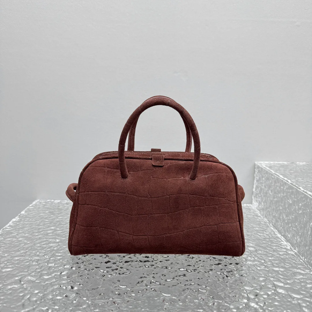 

2025 women top quality Leather scrubbed dark brown bowling bag with hand-held rabbit ear decoration and cracked surface