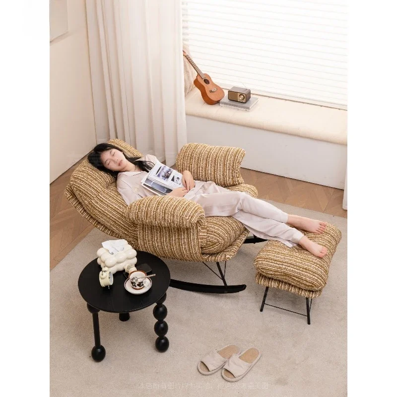 Rocking recliner, antique reclining and sleeping rocking chair on the balcony