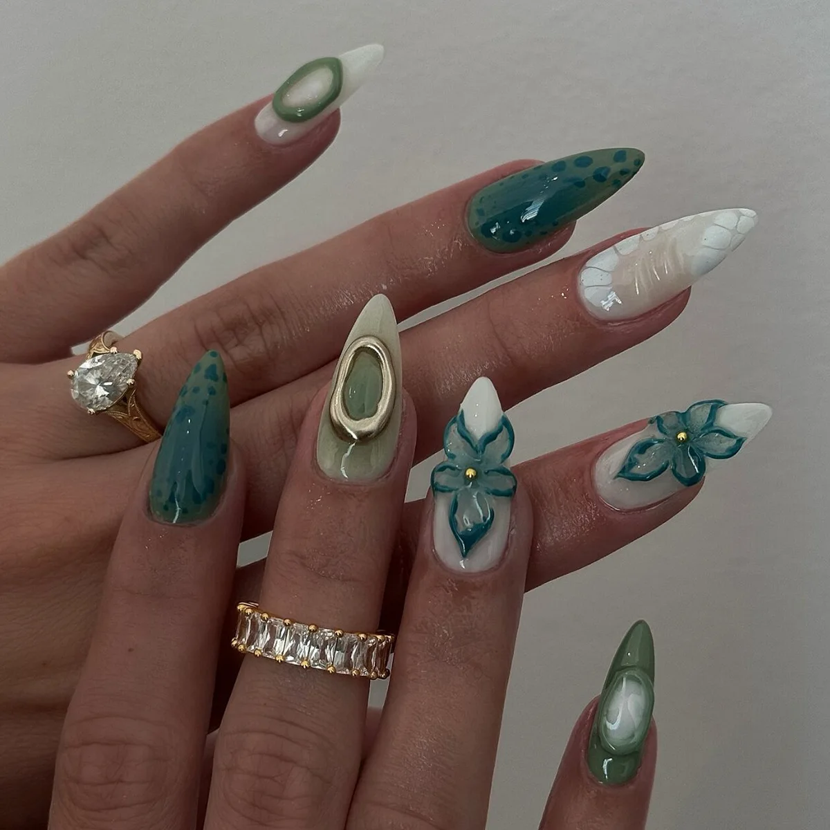 

24Pcs Long Almond Press on Nails-Creamy White Solid Base with Lake Green Gradient Silver Green Irregular Circles Blue Flowers