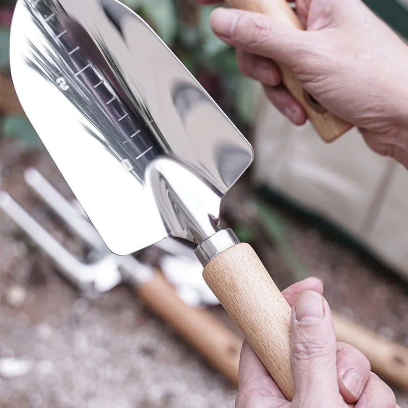 พลั่วขุดดินแบบกว้างสำหรับปลูกเครื่องมือมือในสวนใช้ในกระถางปลูกต้นไม้ใช้ในครัวเรือนอุปกรณ์ทำสวนสำหรับขุดดินปลูกวัชพืช