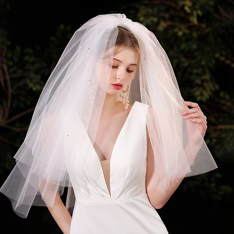 

A white and elegant bridal veil suitable for women's weddings with multiple layers of waist length veils