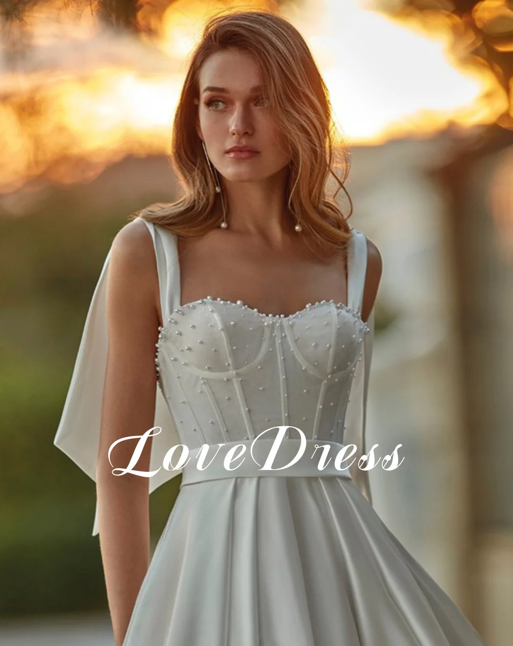 فستان زفاف من LoveDress أبيض عصري على شكل قلب بجيوب بدون أكمام مطرز بفيونكة فستان عروس بسيط من الساتان بدون ظهر بأزرار