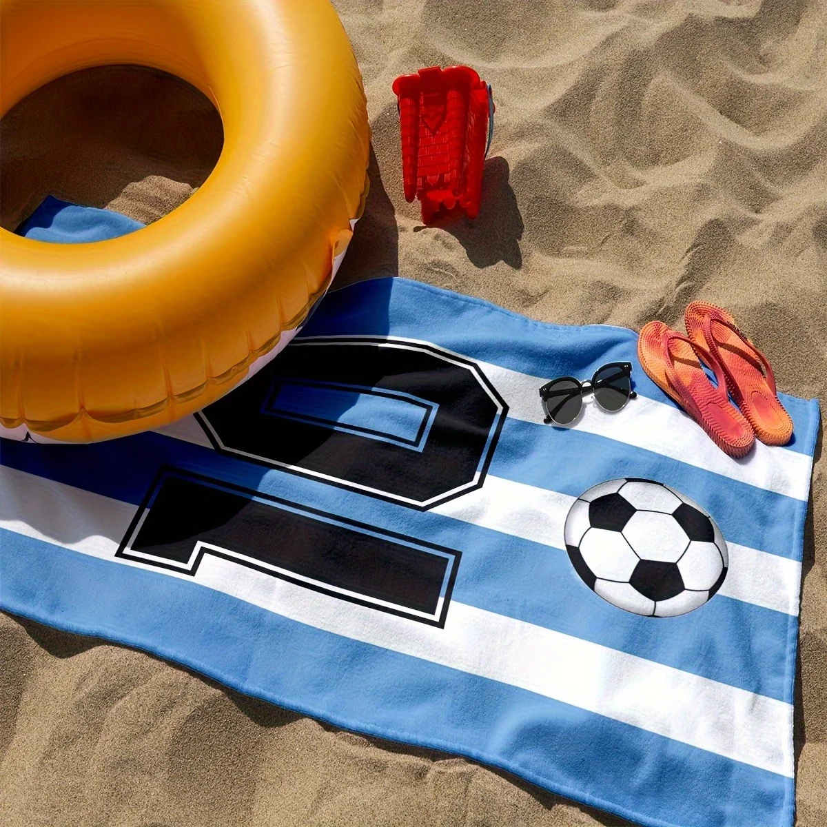 Customize 1pc of Exclusive Beach Towel for Soccer Fans, Featuring Classic Blue and White Stripes with Soccer Elements. Show Off