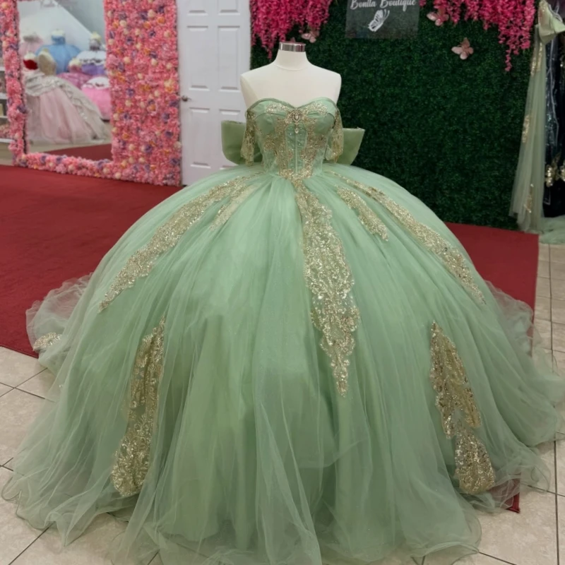 

Green Shiny Ball Gown Quinceanera Dresses 2026 Gold Applique Lace Beading Crystal Bow Tull Off Shoulder Sweet 16 Dress Years