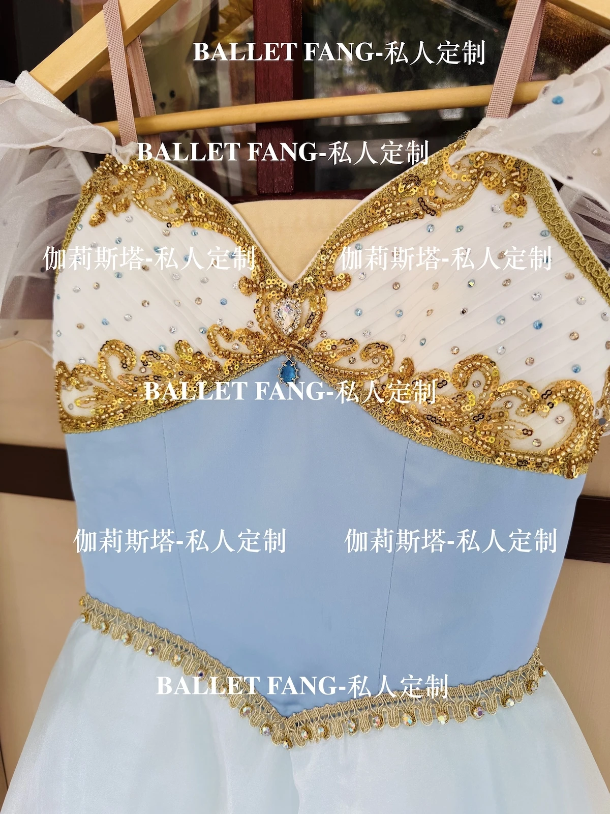 A custom-made ballet dress for the Swan Lake scene, with a blue gradient color, gold sparkling diamonds and a white long chiffon